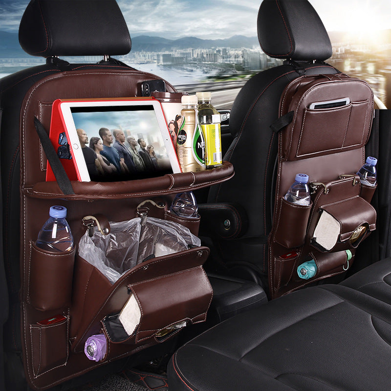 KZ Premium Car Seat-Back Organizer fitted to a front seat with a tablet on the fold-down tray, bottles and tissues in the pockets
