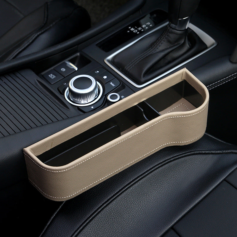 Beige KZ Seat Gap Filler with its open storage tray holding everyday items