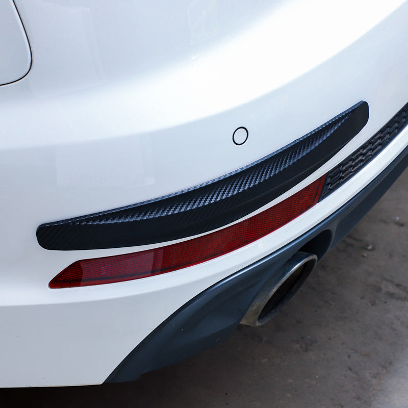 Black carbon-fibre KZ Bumper Guard Strip fitted along the rear bumper of a white car
